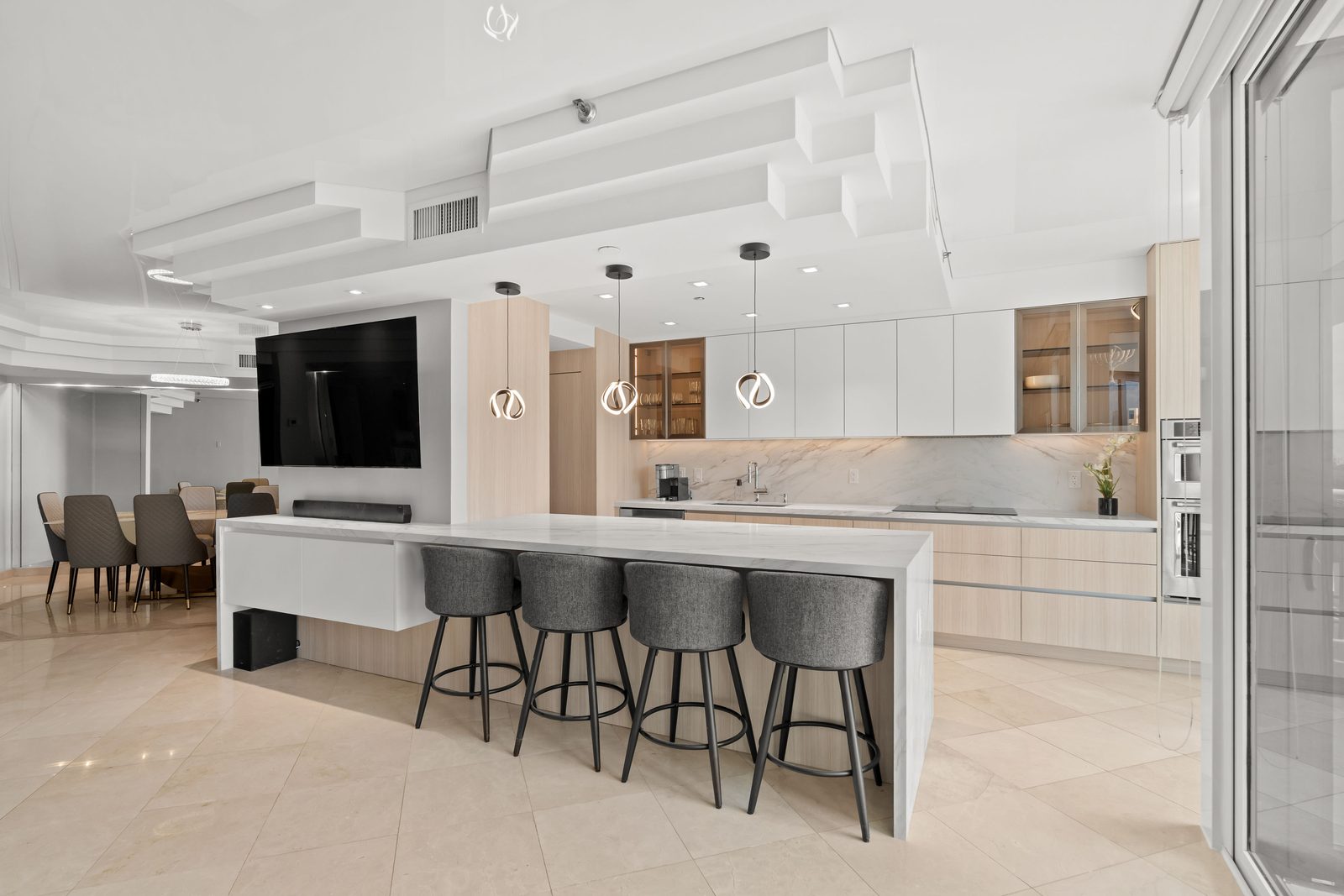 White oak kitchen with marble island in an Aventura condominium