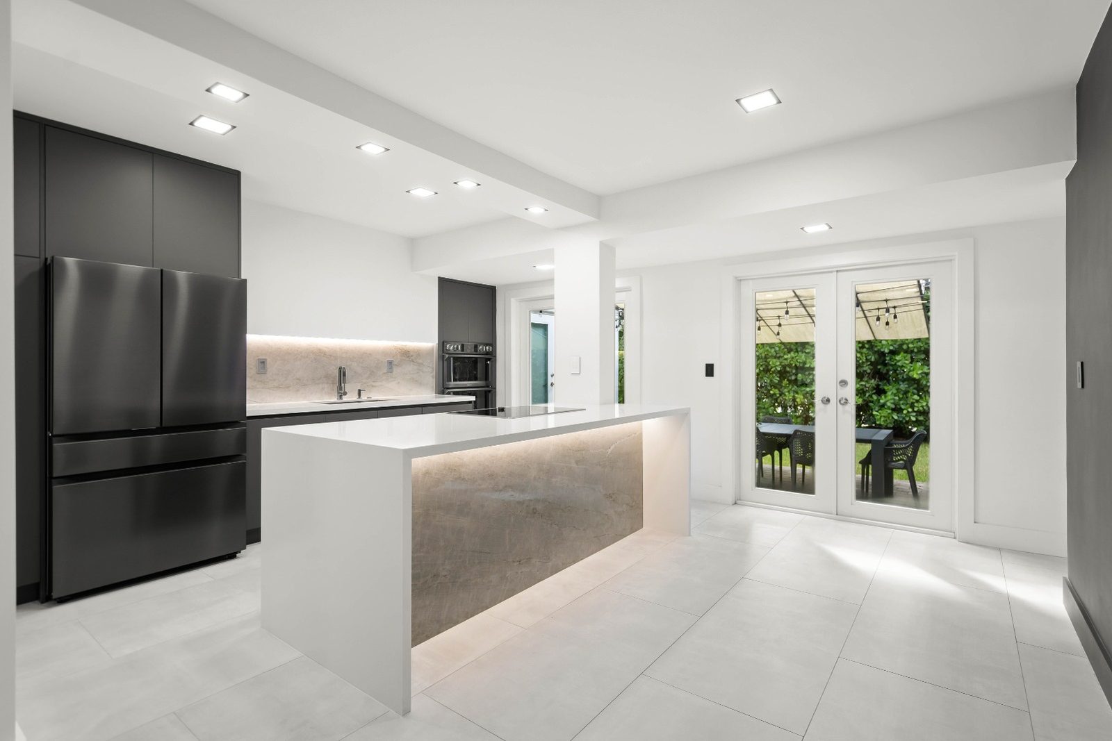 Matte grey and white kitchen with island in a Coral Gables house