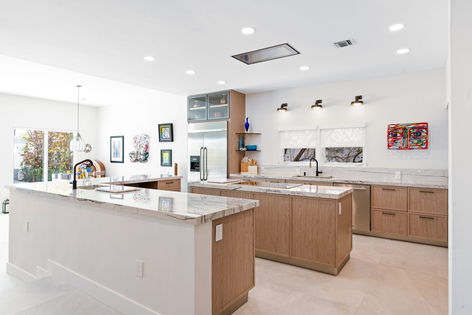 White oak kitchen with marble island in a Golden Beach house