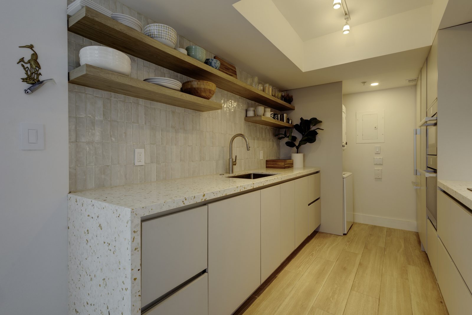 Compact apartment kitchen with terrazzo counter on Alton Road, Miami Beach
