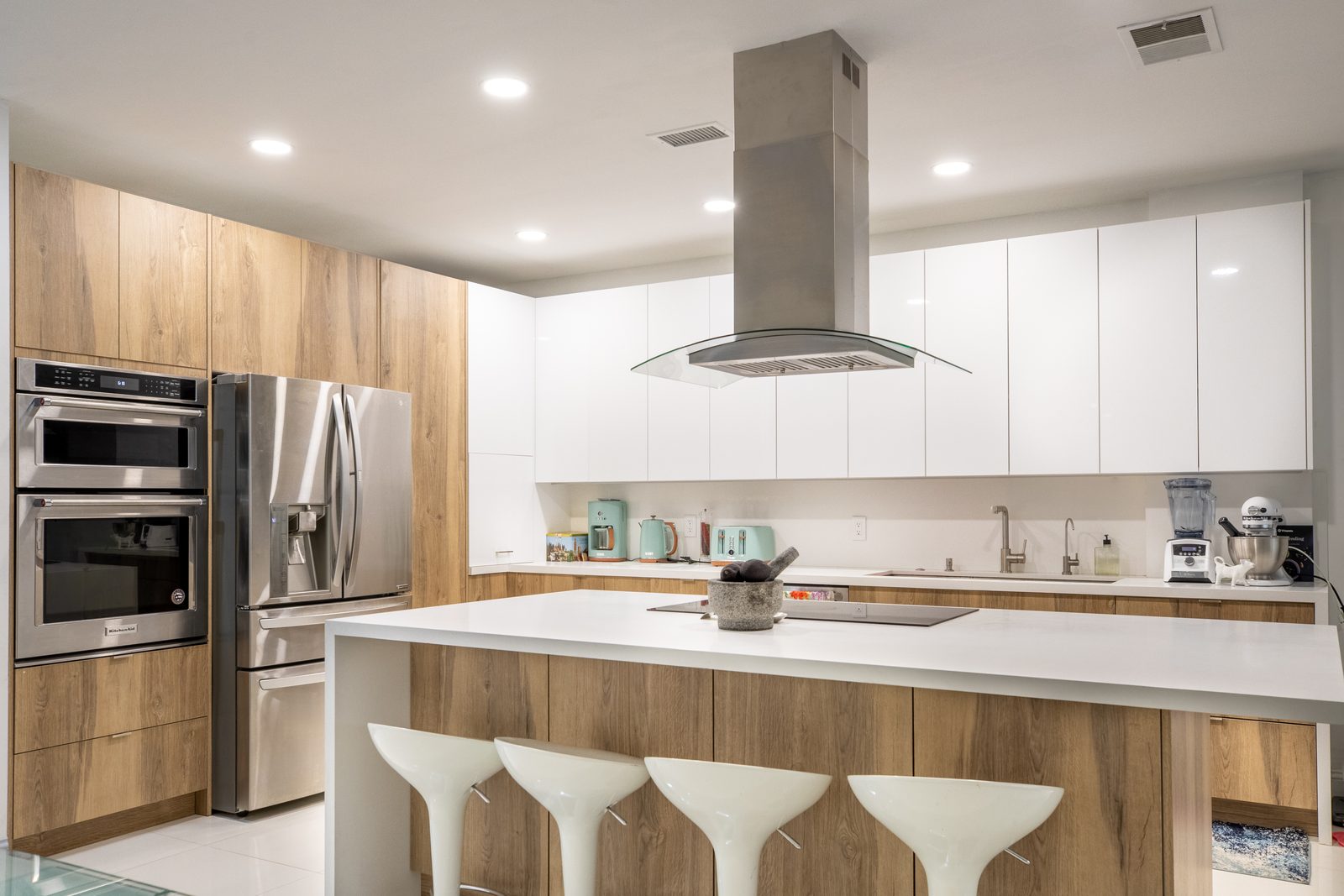 Oak and white kitchen with island in a Sunny Isles Beach home