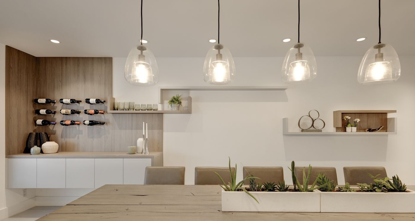 Walnut dining wall with wine display and floating shelves, full-home millwork project