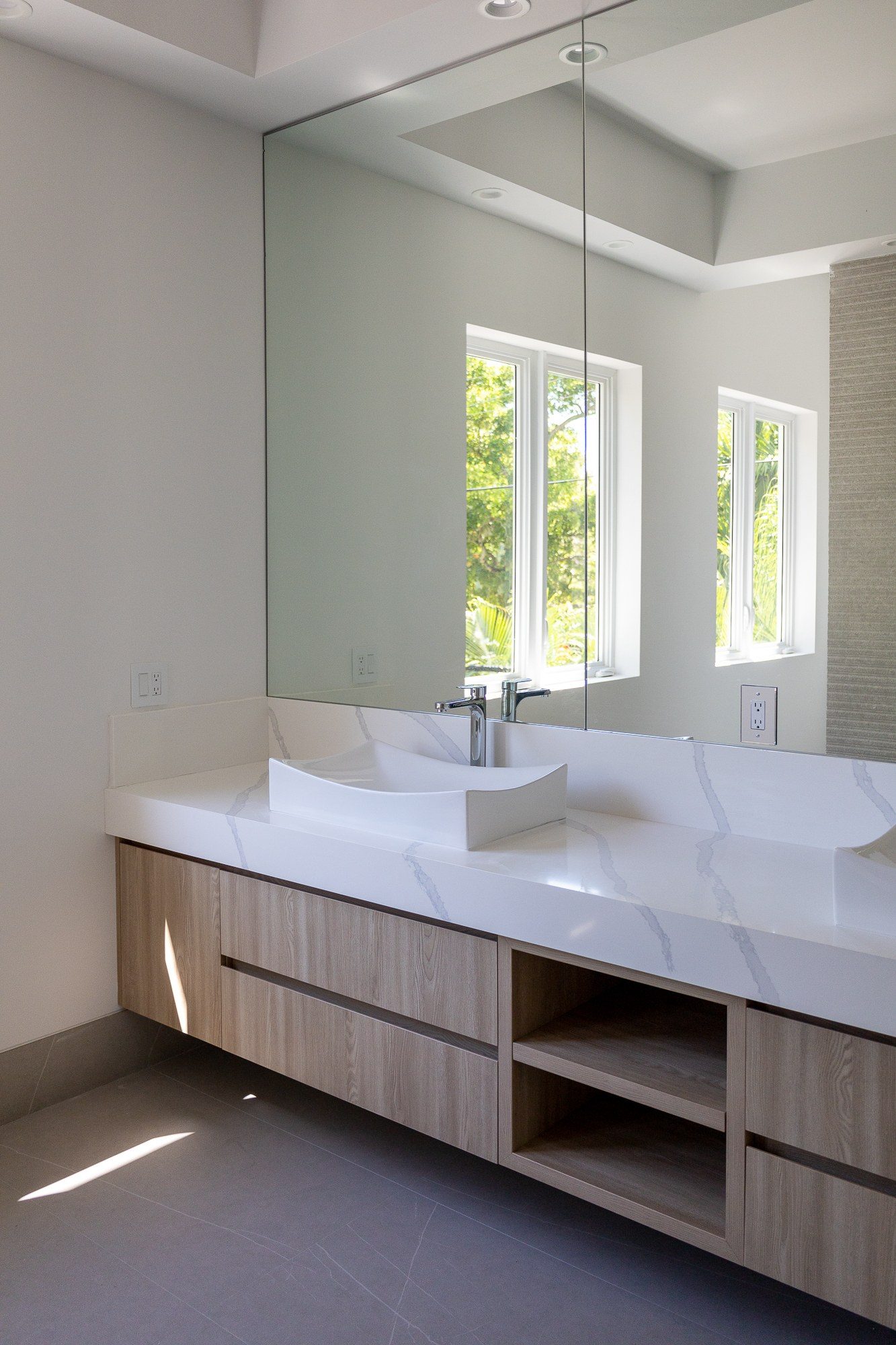 Custom floating bathroom vanity with marble countertop and integrated drawer storage